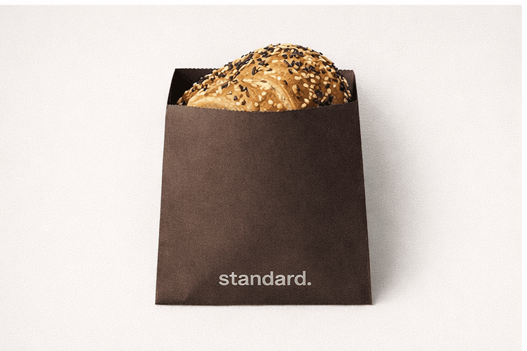Espresso brown pastry bag holding an everything scroll